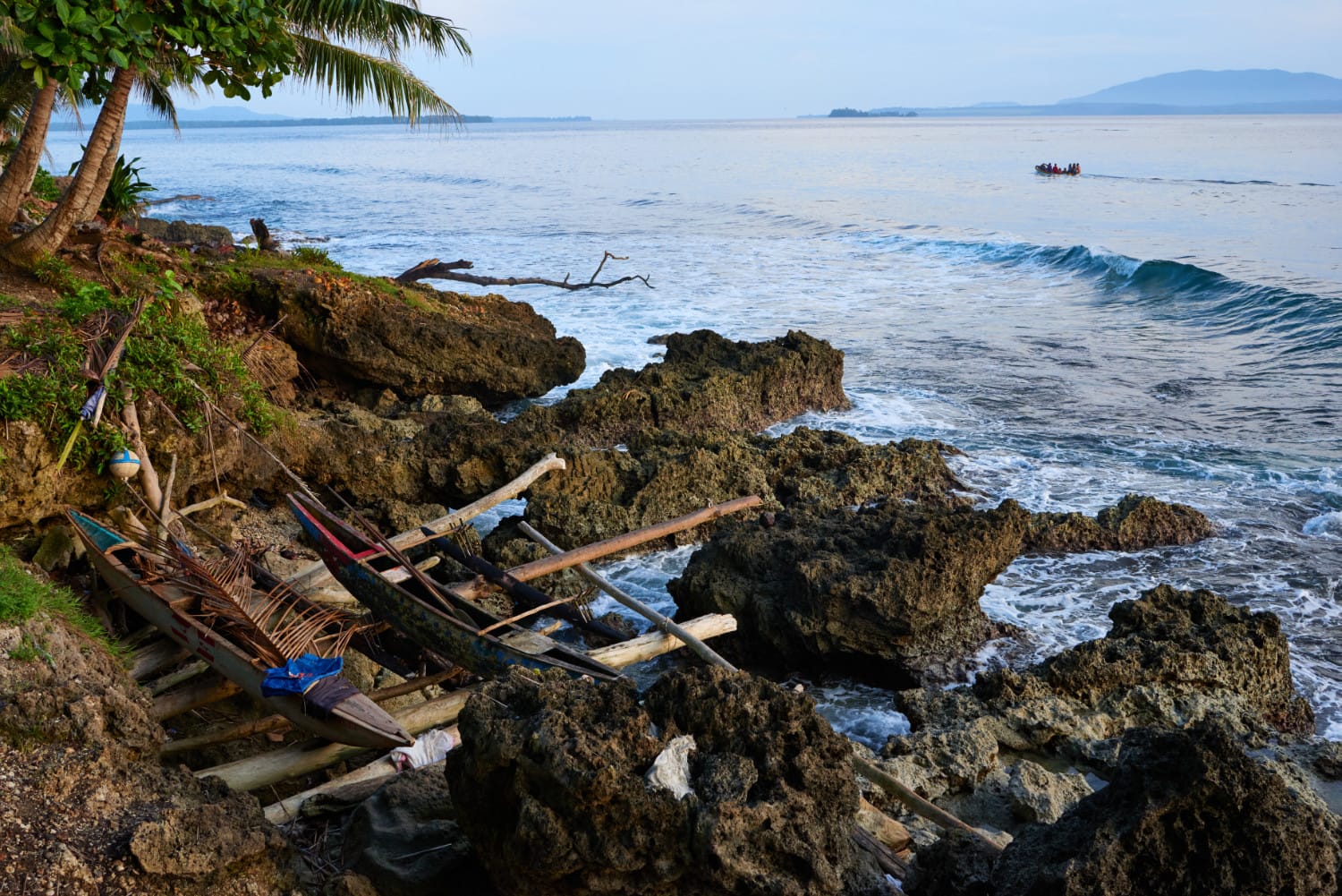 Dugout canoes on the rocky coast, Wewak, Papua New Guinea