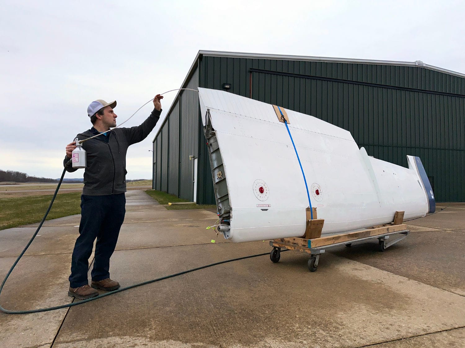 Fogging the wings of a missionary Cessna U206F for shipment to Papua New Guinea.