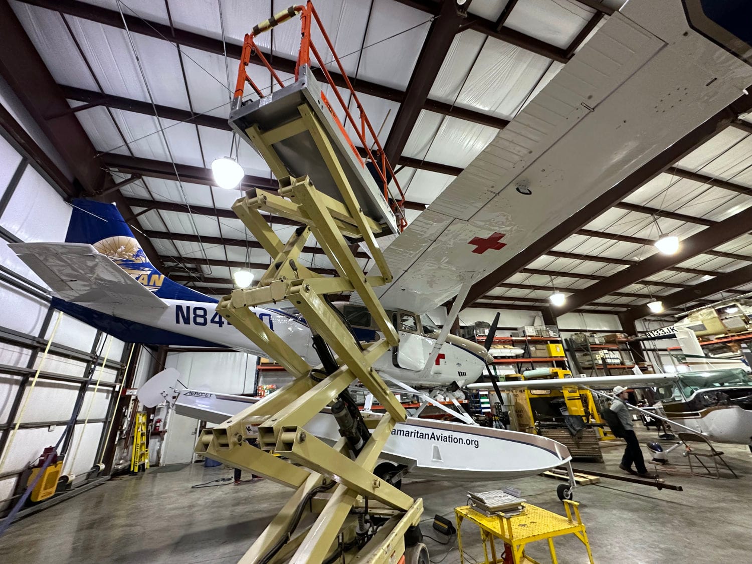 Preparing to lift and disassemble a Cessna 206 missionary float plane to ship it to Papua New Guinea.