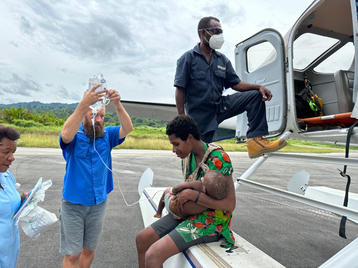 Patient being unloaded from mission aviation floatplane in Papua New Guinea.