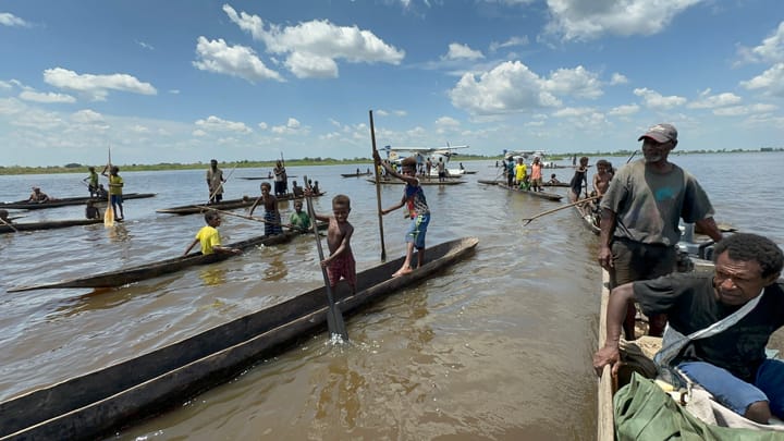 Tribal canoes and two Cessna floatplanes