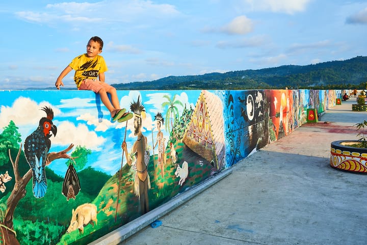 Elliot sitting on Wewak's seawall in Papua New Guinea.